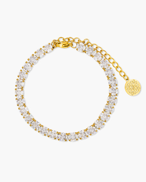 Gold bracelet with clear gemstones on a white background